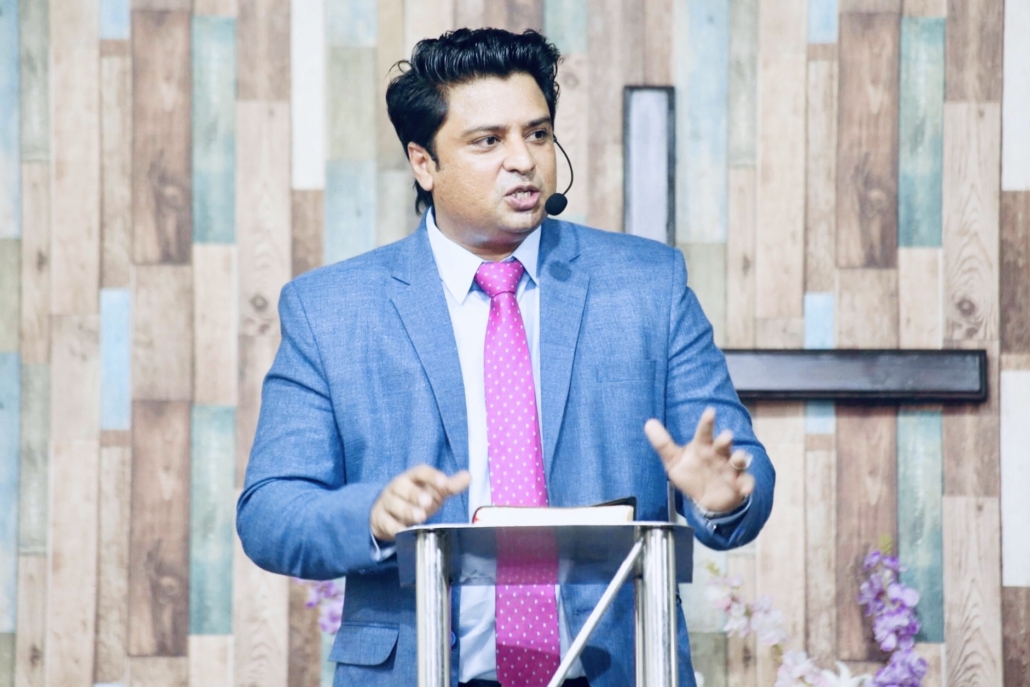 Rev. Dr. Naeem Nasir preaching at the pulpit, Church Planting in Pakistan