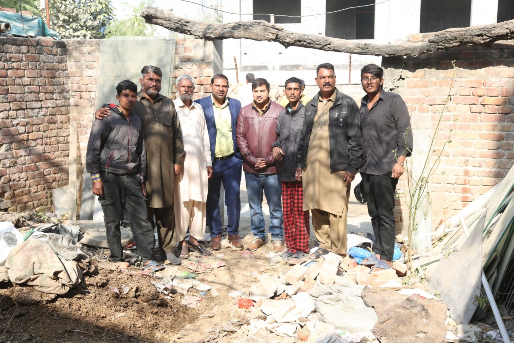 Good Samaritan Ministries Pakistan team standing on newly secured church land in Johar Town 2025