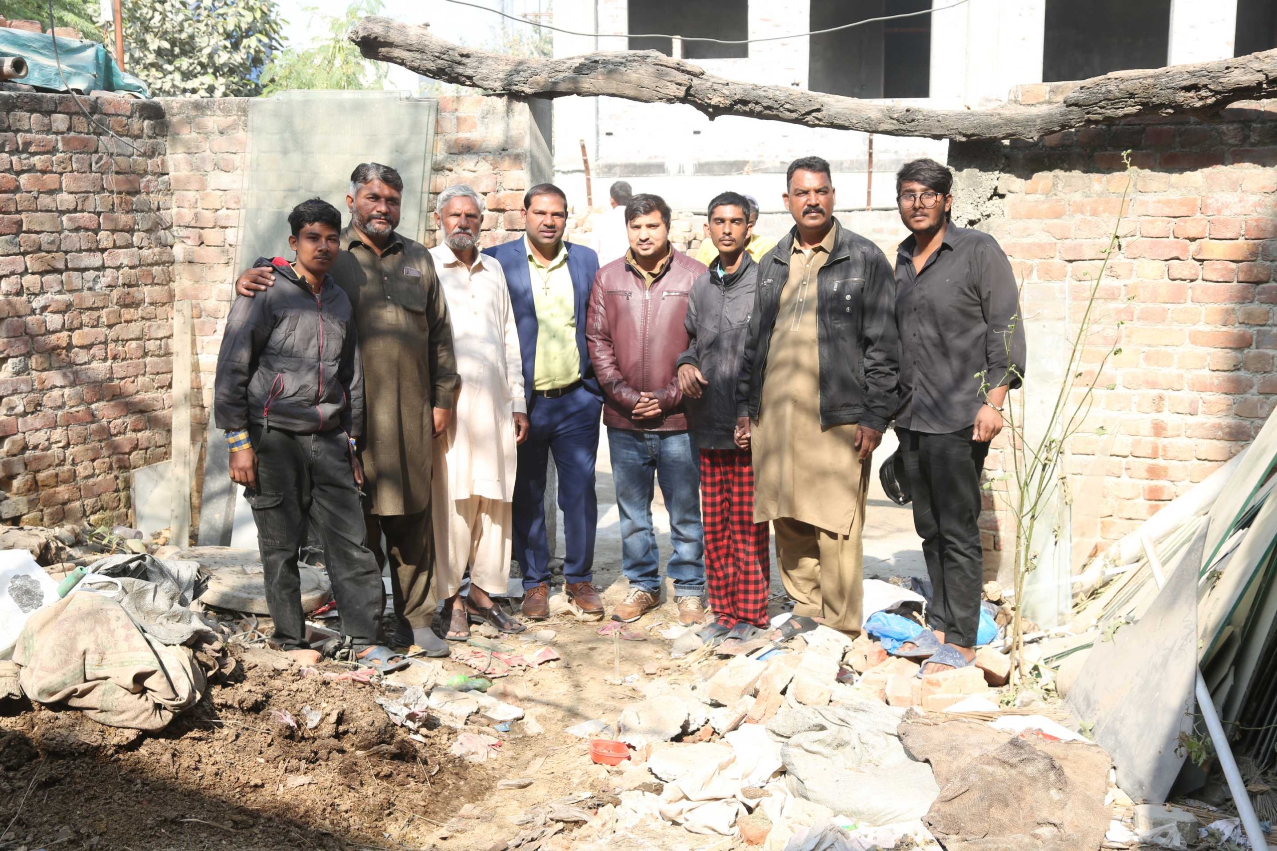 Good Samaritan Ministries Pakistan team standing on newly secured church land in Johar Town 2025