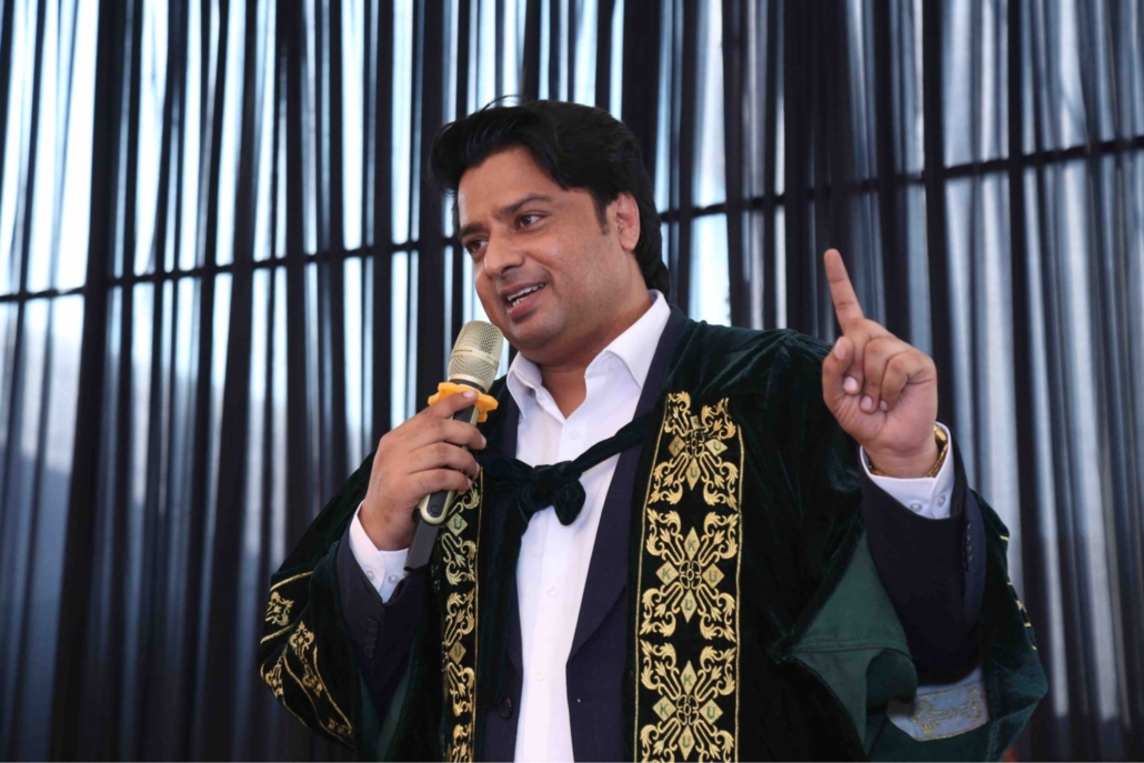 Rev. Dr. Naeem Nasir, Church Planting in Pakistan: in graduation gown with the microphone